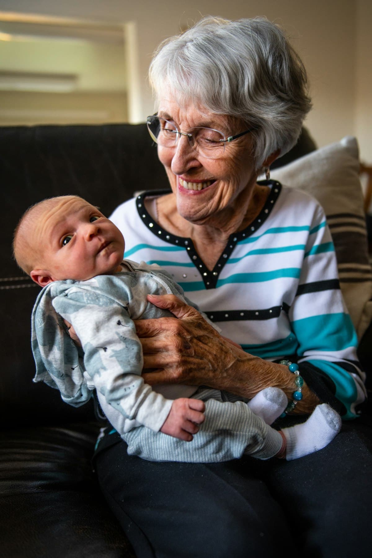 A grandmother holding her newborn grandchild
